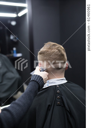 Haircut men typewriter close-up. Barber cuts a man. 61460961