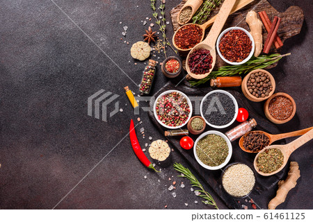 Spices and herbs over black stone background 61461125