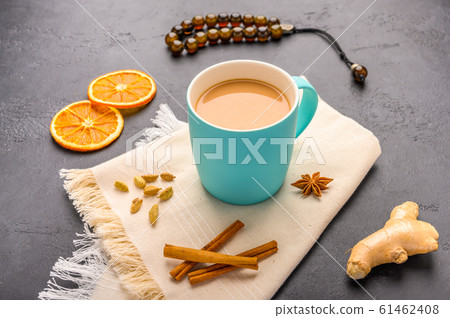 Traditional Indian masala tea chai with milk and spices on napkin on dark stone background with Traditional Indian masala tea chai with milk and spices on napkin on dark stone background with 61462408