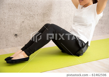 Woman doing muscle training Woman doing muscle training 61462506