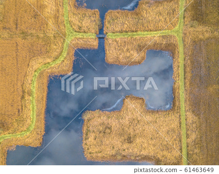 Walking path along straight square ponds 61463649