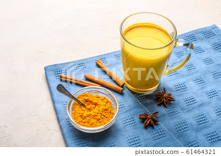 Cup of traditional indian masala chai tea with ingredients above over white texture background 61464321