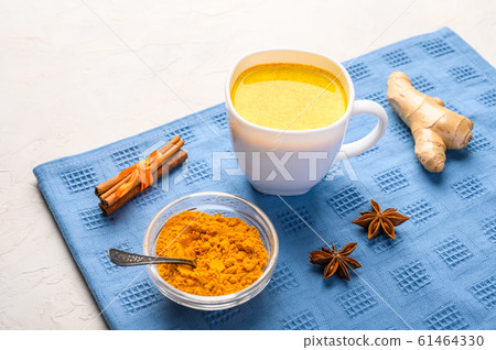 Cup of traditional indian masala chai tea with ingredients above over white texture background 61464330