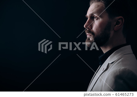 Handsome Brunet Bearded Man in Light Jacket Side View Handsome Brunet Bearded Man in Light Jacket Side View 61465273