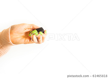 Woman holding green mint nail polish in hand Woman holding green mint nail polish in hand 61465818