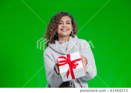 Christmas Shopping and sales concept. Charming afro-american female happy to buy a present in holidays time. Christmas Shopping and sales concept. Charming afro-american female happy to buy a present in holidays time. 61468253