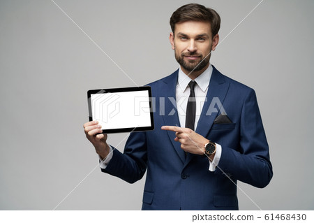 Young Businessman presenting digital tablet pc pad with blank screen Young Businessman presenting digital tablet pc pad with blank screen 61468430