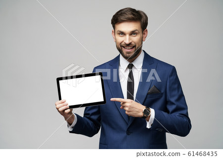 Young Businessman presenting digital tablet pc pad with blank screen Young Businessman presenting digital tablet pc pad with blank screen 61468435