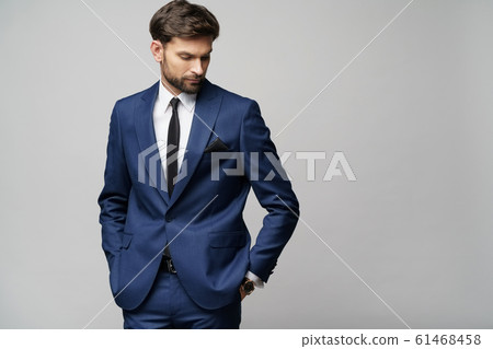 studio photo of young handsome businessman wearing suit 61468458