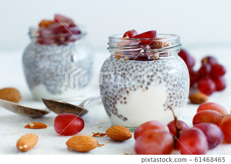 Chia pudding parfait with red grapes and almonds 61468465