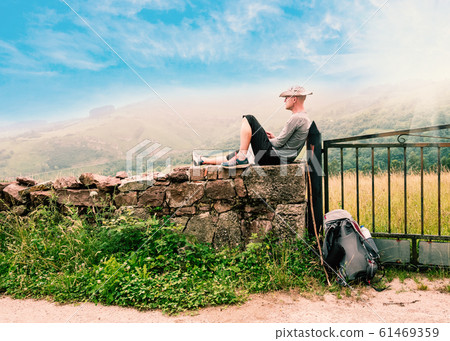 Lonely Pilgrim with backpack resting. Camino de Santiago 61469359