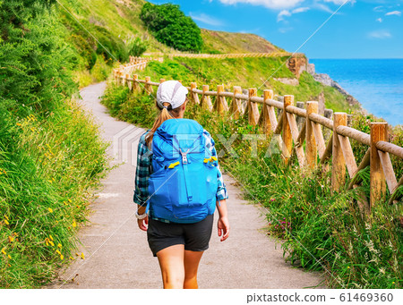 Lonely Pilgrim with backpack walking the Camino de Santiago in Spain, Way of St James 61469360