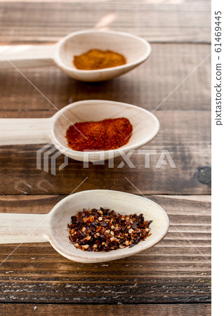 Three large wooden spoon with spices on rustic Three large wooden spoon with spices on rustic 61469445