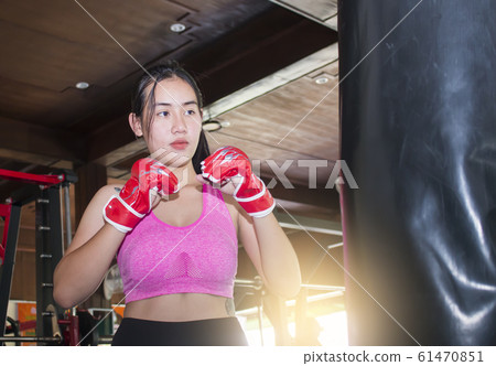 Young asian woman doing boxing training at the gym Young asian woman doing boxing training at the gym 61470851