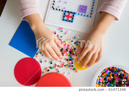 Kids playing iron beads at home 61471346