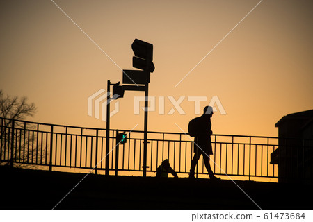 man walking  with backpack on the bridge  61473684