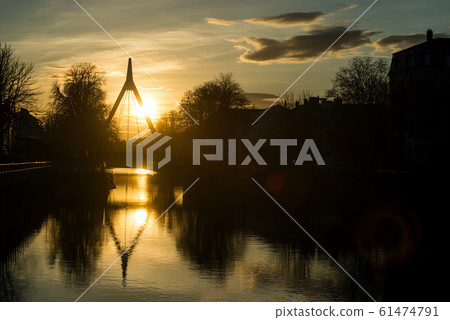 panorama with silhouette of suspended bridge under the channel with reflection by sunset panorama with silhouette of suspended bridge under the channel with reflection by sunset 61474791