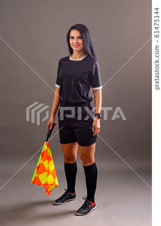 Beautiful Soccer Referee with flag in hand looking at camera and smile 61475144