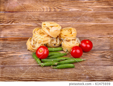 Pasta on the wooden background with tomato, Pasta on the wooden background with tomato, 61475939