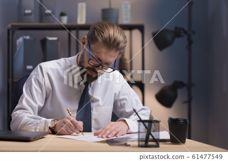 Concentrated Mature Bearded White Collar in Glasses Writing Concentrated Mature Bearded White Collar in Glasses Writing 61477549