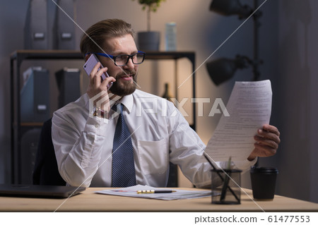A Enthusiastic Bearded Businessman Adjusting Contract Terms A Enthusiastic Bearded Businessman Adjusting Contract Terms 61477553