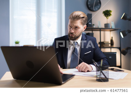 Handsome Sedate Company CEO With Eyebrow Up Working Handsome Sedate Company CEO With Eyebrow Up Working 61477561