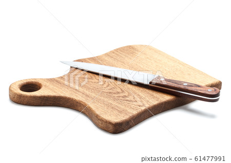 Large stainless steel cook knife with wooden handle lies on handmade cutting board made of solid oak 61477991