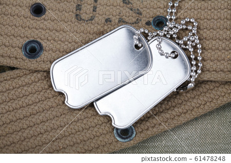 A pair of blank dog tags on U.S. Army uniform 61478248