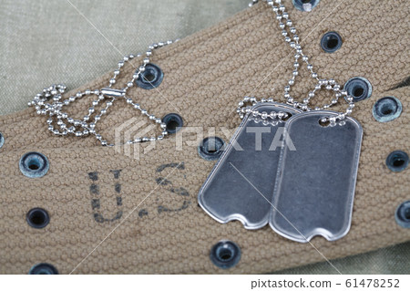 A pair of blank dog tags on U.S. Army uniform 61478252