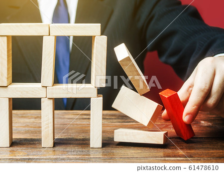 A businessman removes an important component causes collapse of entire complex system. Incompetent businessman. Inexperience, unprofessional leader. Failure. Making wrong decisions, ruining business. 61478610