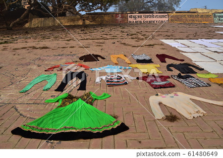 Laundry hanged on brick slopes of Ghats along the Ganges River, Varanasi, India's World Heritage Site 61480649