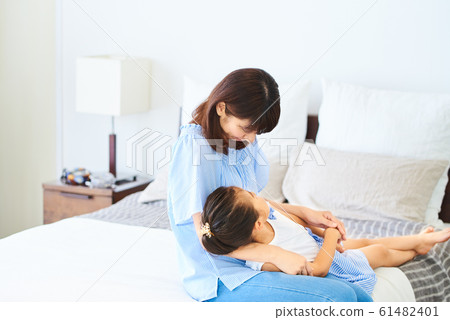 Parent and child with knee pillow bright indoor Parent and child with knee pillow bright indoor 61482401