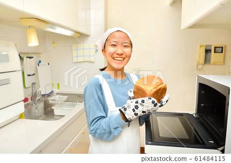 Girl baking bread in the kitchen Girl baking bread in the kitchen 61484115