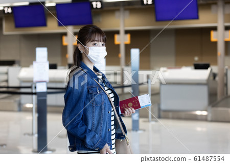 Woman wearing airport mask 61487554
