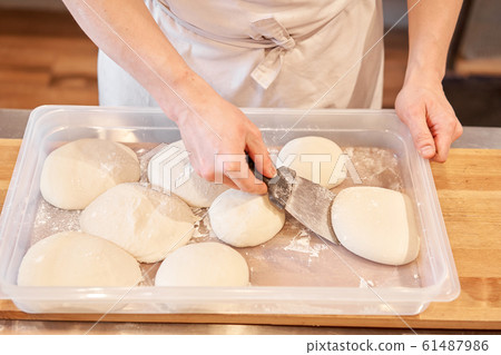 Dough for Neapolitan pizza. Closeup hand of chef baker in uniform white apron cook pizza at kitchen Dough for Neapolitan pizza. Closeup hand of chef baker in uniform white apron cook pizza at kitchen 61487986