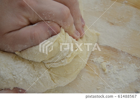 cook kneads pizza dough with his hands cook kneads pizza dough with his hands 61488567