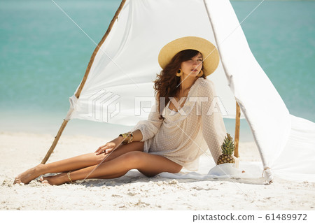 Woman Resting on the Beach During Vacation 61489972
