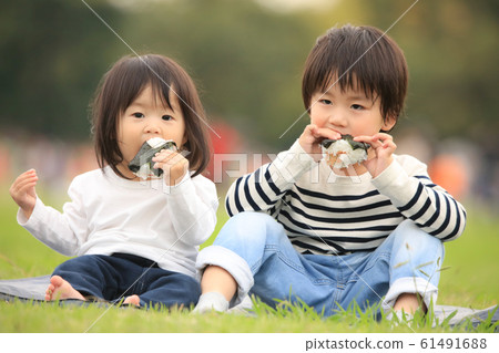 Children eating rice balls Children eating rice balls 61491688
