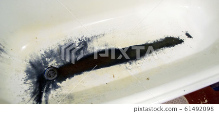 Very old rusty shabby bath close-up. A bath with peeling white Very old rusty shabby bath close-up. A bath with peeling white 61492098