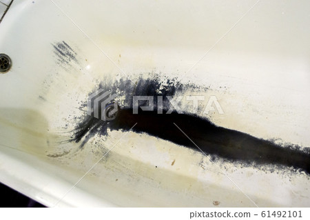 Very old rusty shabby bath close-up. A bath with peeling white 61492101
