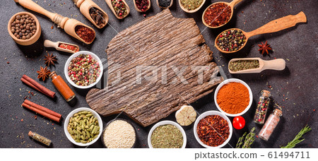 Spices and herbs over black stone background 61494711