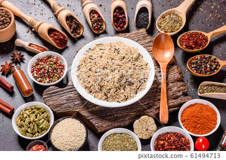 Spices and herbs over black stone background Spices and herbs over black stone background 61494713