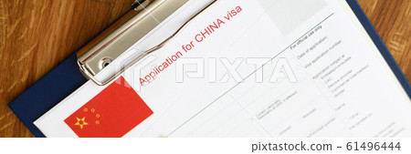 Red passport with silver pen lie against schengen 61496444