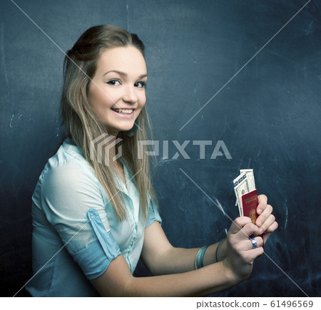 portrait of cute girl student with money and passport 61496569