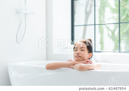 A woman taking a bath 61497954