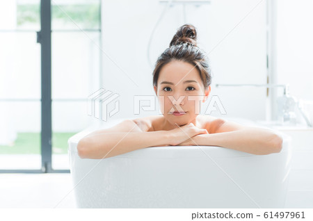 A woman taking a bath A woman taking a bath 61497961
