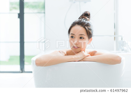 A woman taking a bath 61497962