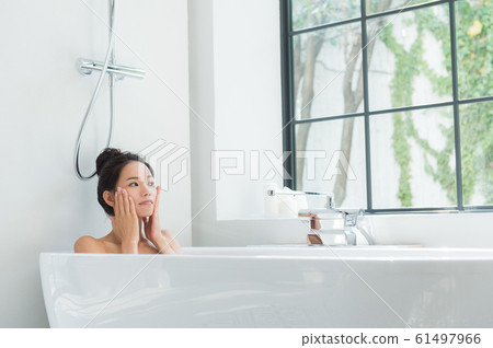 A woman taking a bath 61497966
