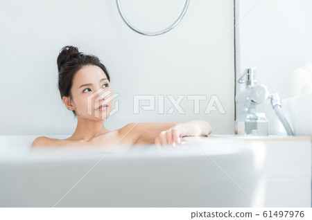 A woman taking a bath 61497976
