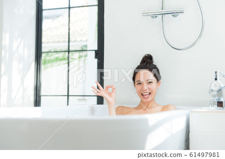 A woman taking a bath A woman taking a bath 61497981